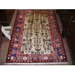 A Persian light ground bordered rug with stylized