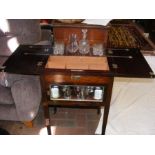 An unusual mahogany cased drinks cabinet with pop-