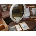 An oval antique wall mirror together with engravin