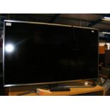 A Samsung flat screen TV with remote