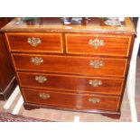 A reproduction inlaid chest of drawers