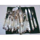 A set of silver fruit knives and forks with mother