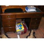 A military teak knee hole desk with sunken brass h