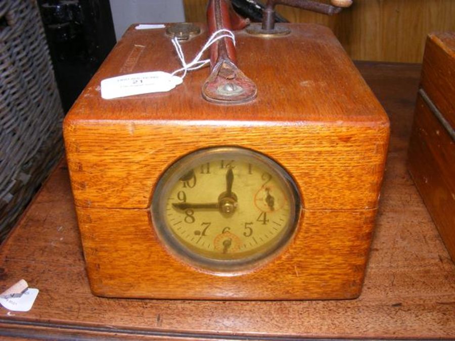 A pigeon racing clock in oak case