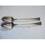 A pair of silver basting spoons with Georgian Lond