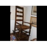 A ladder back rocking chair with rush seat