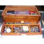A wooden jewellery box containing costume jeweller