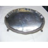 A 26cm silver salver with 'pie-crust' border on ba