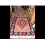 Two geometric patterned rugs