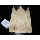 A carved antique ivory relief triptych