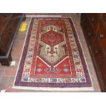 A Persian red ground rug with geometric design - 1