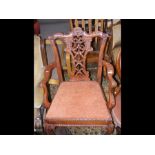 An antique style carver chair with carved backrest