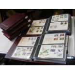 A selection of GB First Day Covers in five maroon