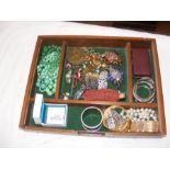 A tray of costume jewellery including brooches, ne