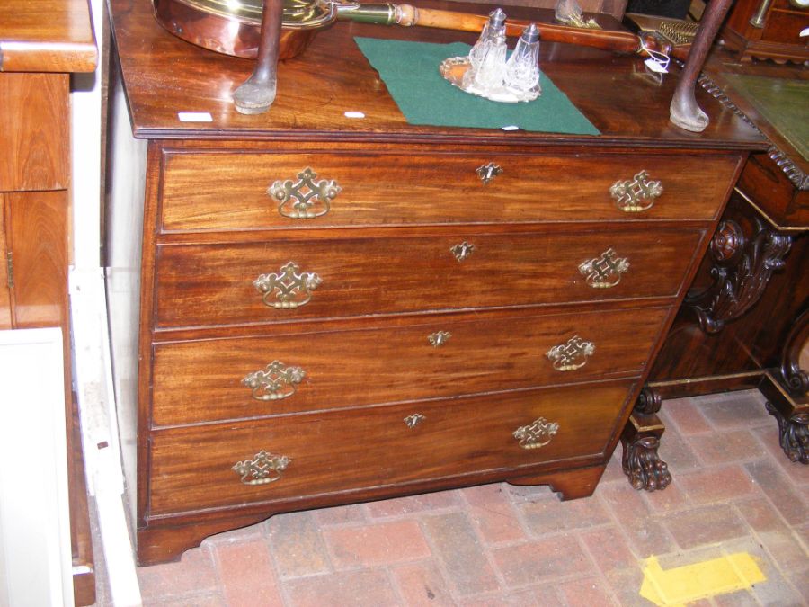 An early 19th century mahogany chest of four long