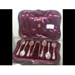 An interesting cased set of silver teaspoons with