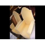 A pair of high back yellow armchairs
