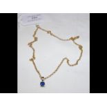 A 9ct gold necklace with blue stone pendant