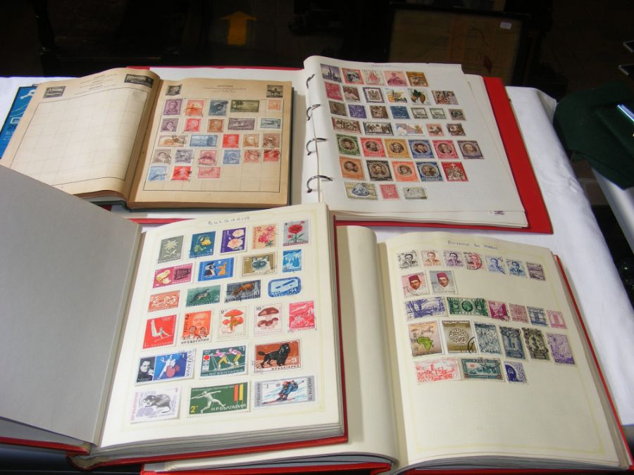 Four albums of collectable stamps including Ceylon