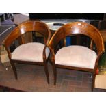 A pair of curved back tub chairs