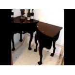 A pair of Victorian corner tables on carved cabrio