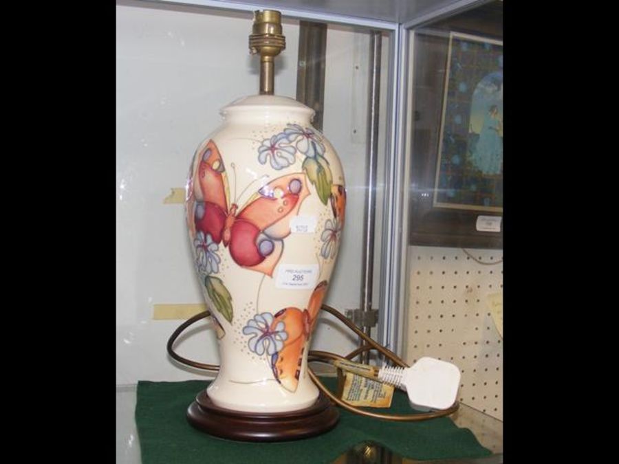A Moorcroft pottery table lamp with butterfly deco