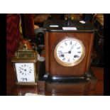 A wooden mantel clock together with a carriage clo