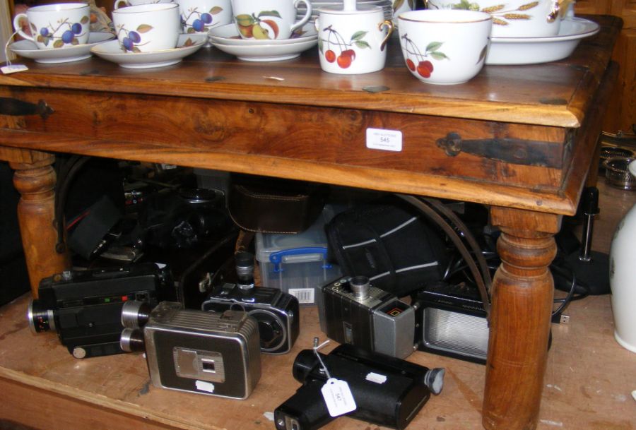 A square hardwood coffee table with wrought iron d