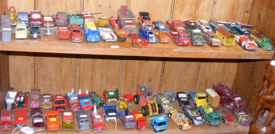 Two shelves of play worn die cast model vehicles