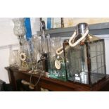 A mantel clock, drink dispenser, glass vases