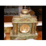 A green onyx mantel clock with gilt columns and tw