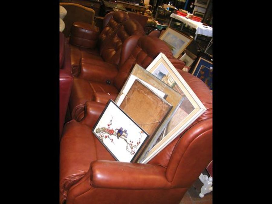 A three-piece suite in brown leather style upholst