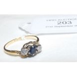 A diamond and sapphire ring in gold setting