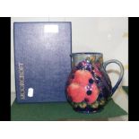 A Moorcroft pottery jug with tube line grape decor