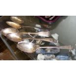 Five silver serving spoons