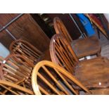A set of four antique stick back dining chairs