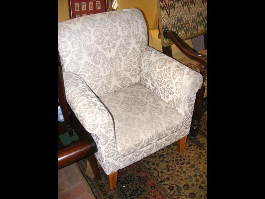 An easy chair in light silver material