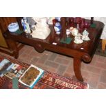 A mahogany coffee table on shaped supports