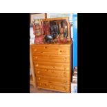 A pine chest of drawers with mirror over