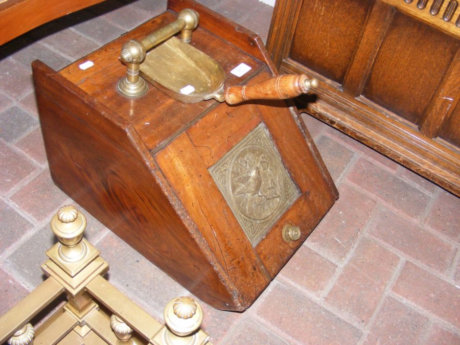 An antique coal scuttle with shovel