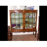 A walnut two door display cabinet on cabriole supp