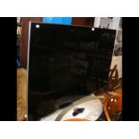 An LG 55'' flat screen TV with remote and owner's ma