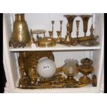 Two shelves of brass metal ware