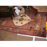 A Middle Eastern rug with geometric border and cen