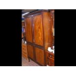 A mahogany wardrobe with panelled doors