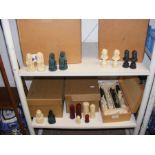 A number of chess piece sets - on two shelves