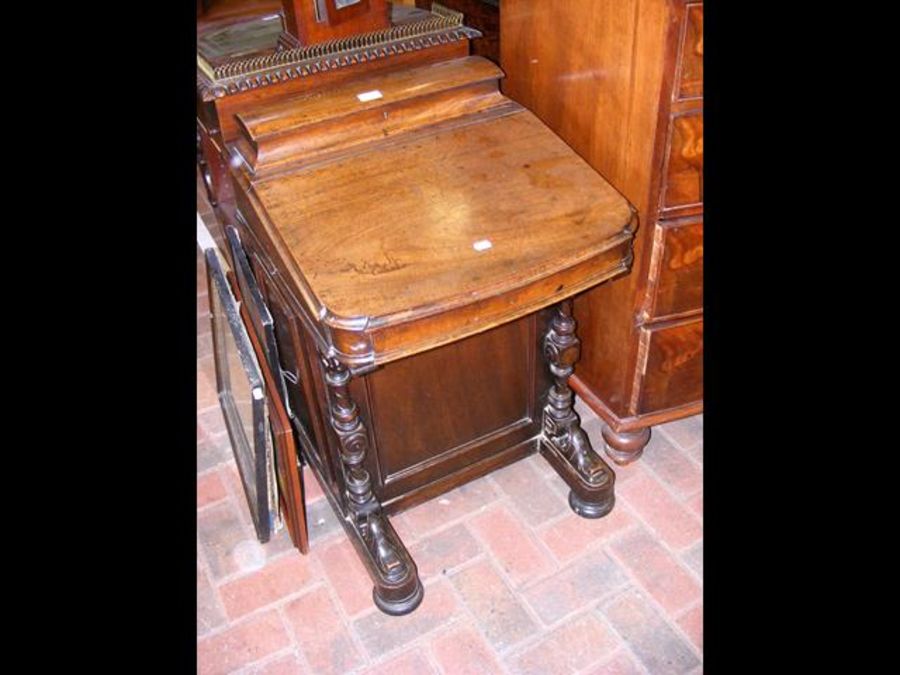 A Victorian mahogany Davenport with stationery com