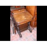 A Victorian mahogany Davenport with stationery com