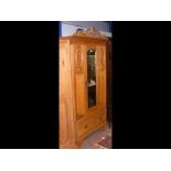 An early 20th century satinwood wardrobe with pedi