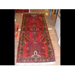 A Middle Eastern style runner with geometric borde
